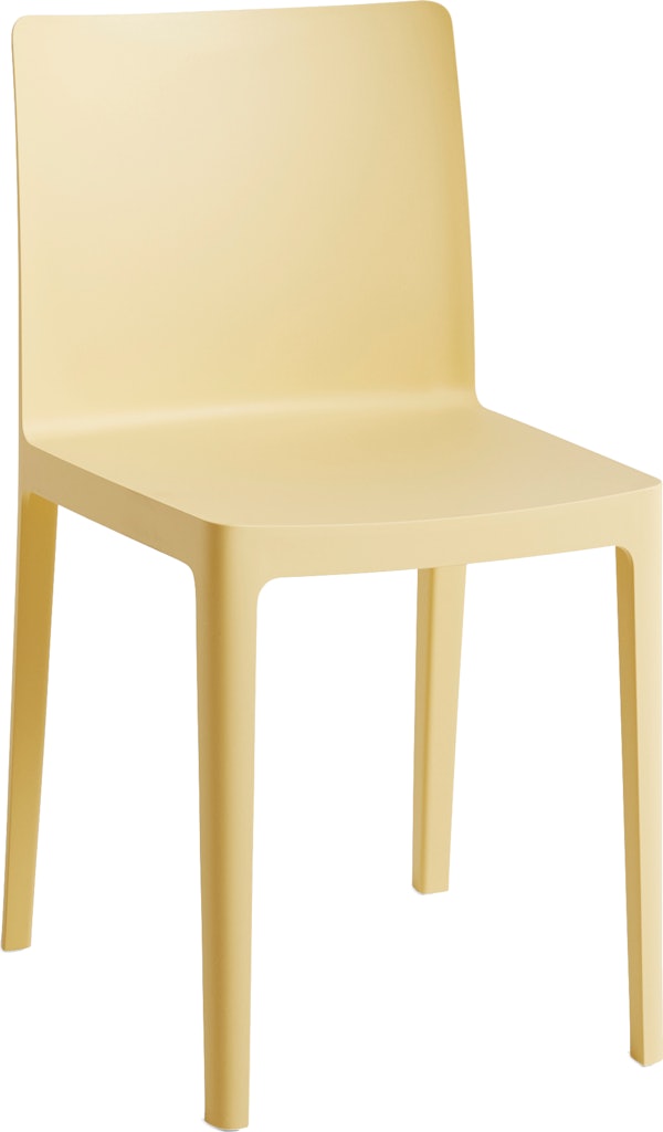 A three quarter angle view of a yellow Elementaire Side Chair.
